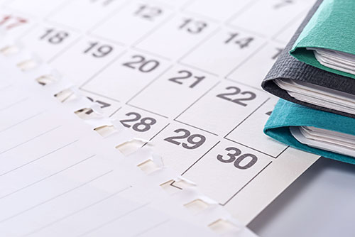 Calendar and file folders on a desk