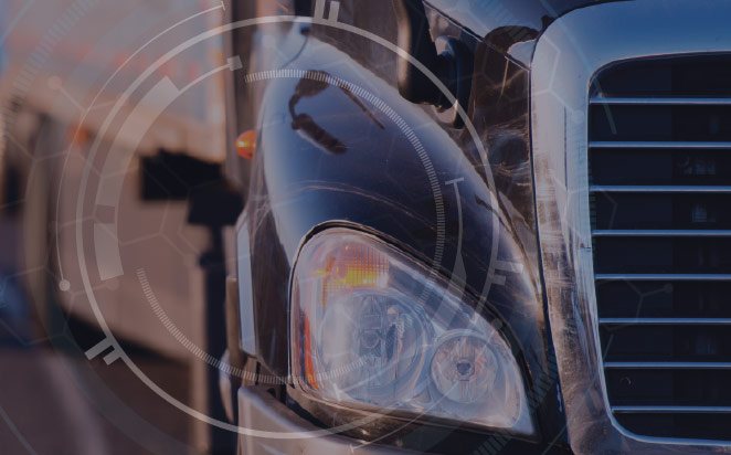 Close-up of truck headlight with technology symbols