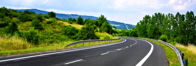 Peaceful country road with hills in distance