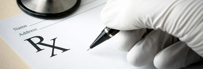 Close-up of doctor&#39;s hand writing prescription