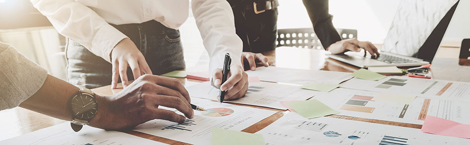 Underwriting People reviewing charts and graphs