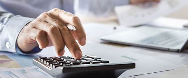 Business person crunching numbers with calculator